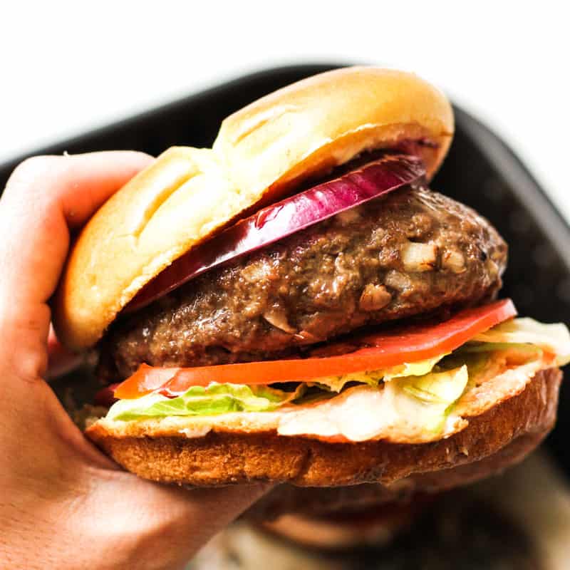 air fryer bison burger in hand