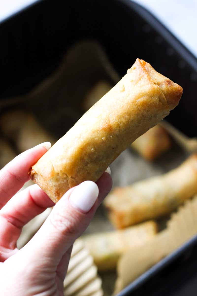 a piece of trader joe's spring roll in hand